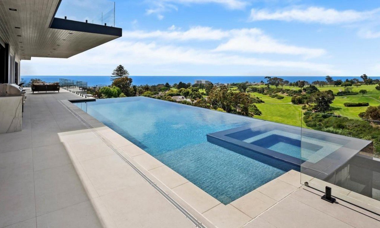 https://ansconstruction.us/wp-content/uploads/2026/10/infinity-pool-golf-ocean.jpg