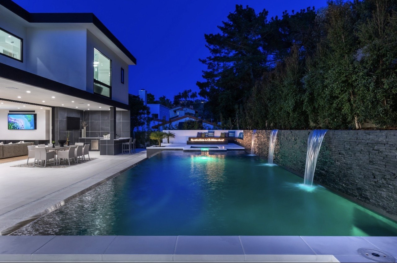 https://ansconstruction.us/wp-content/uploads/2026/10/pool-twilight-waterfall.jpg